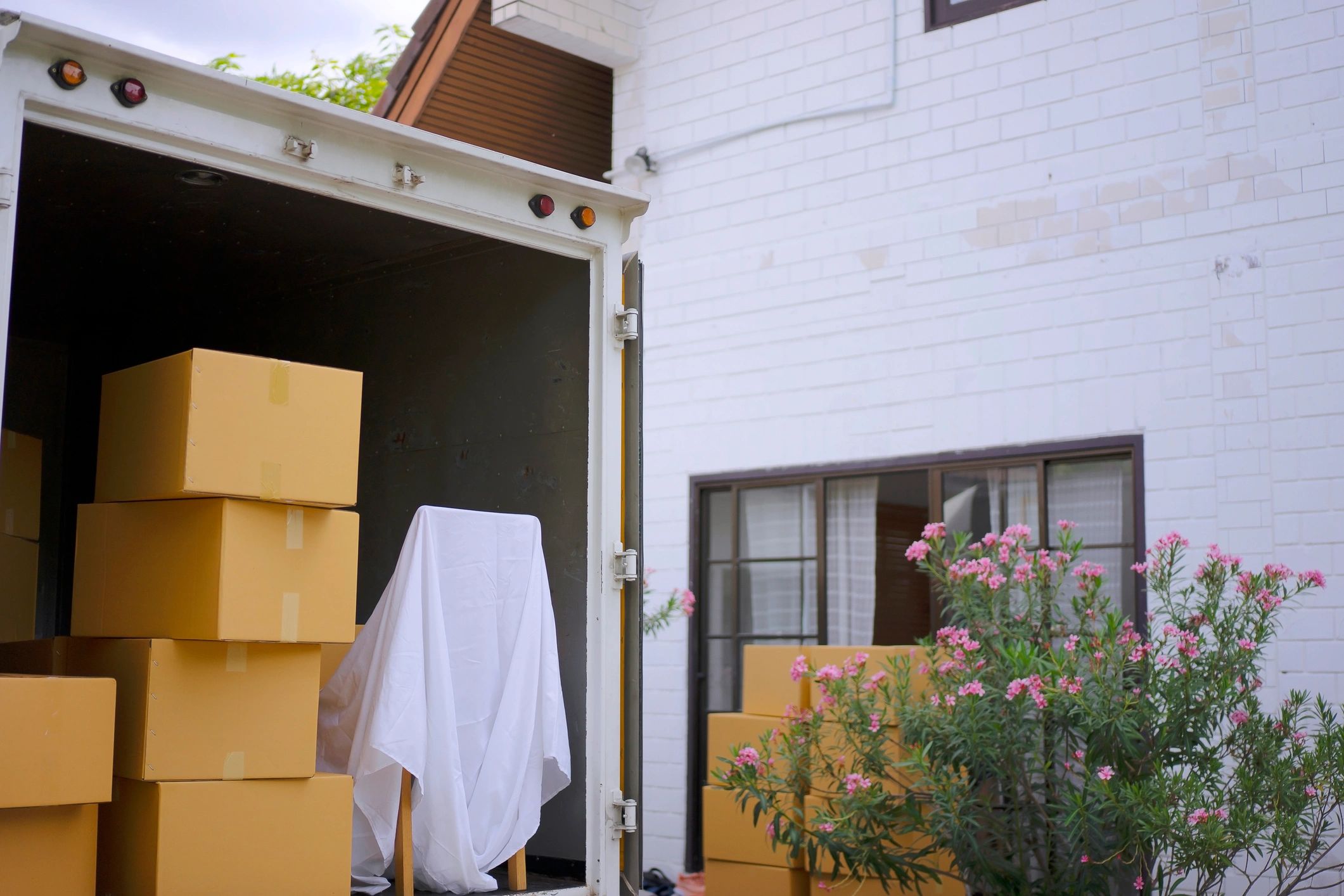 Delivery worker carrying packages to a home